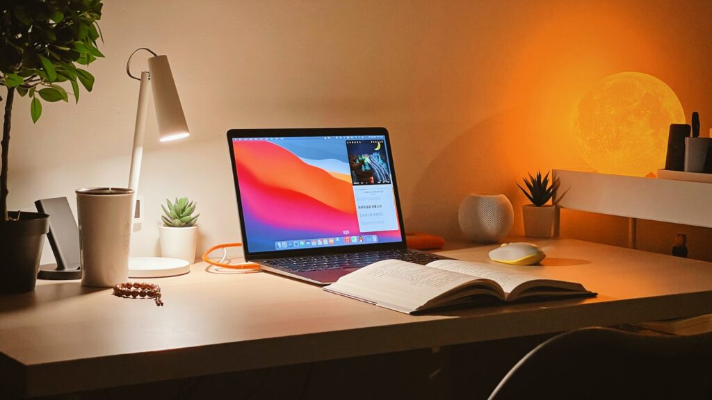 macbook pro on white wooden desk